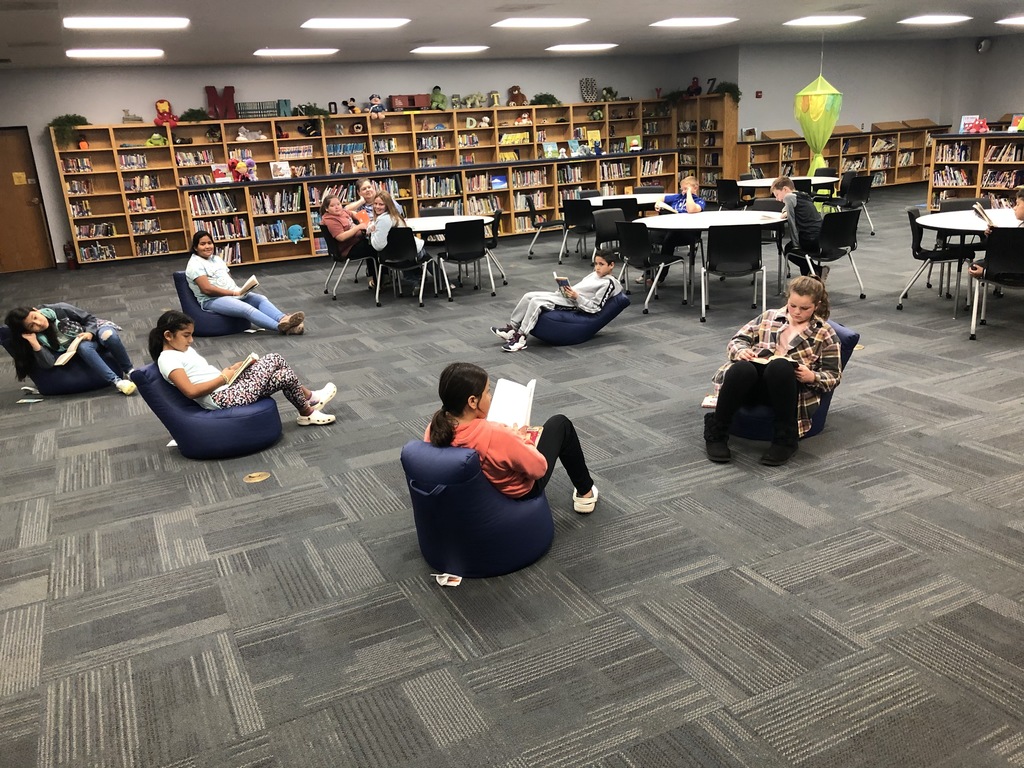 students enjoying new bean bags chairs in the library