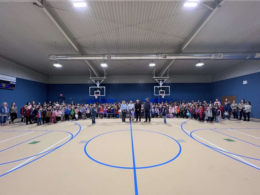 students at ribbon cutting in new gym